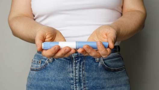 blue-injection-pen-in-female-hand-GettyImages-2155518118-3000x2000.jpg