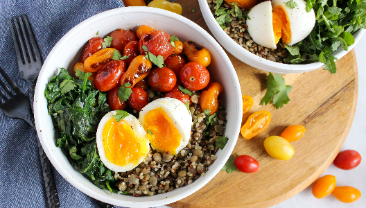 Bowl of lentils, quinoa, spinach, and blistered tomatoes