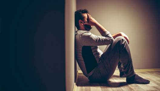 man-sitting-on-floor-GettyImages-1185422927-3000x2000.jpg