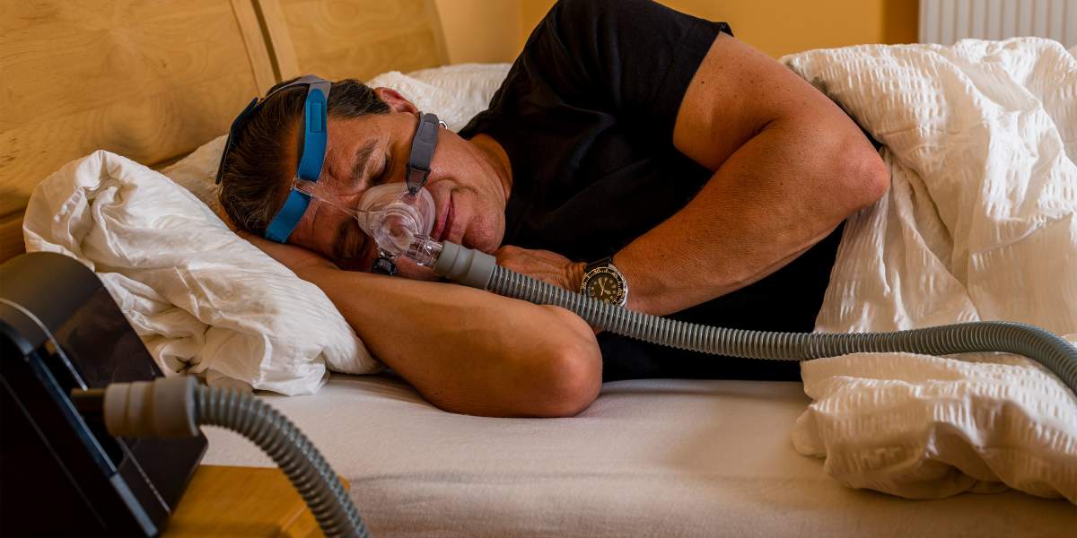 man-sleeping-with-cpap-mask-GettyImages-1263374923-3000x2000.jpg