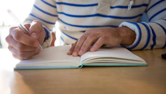 man-writing-in-a-diary-GettyImages-652195046-3000x2000.jpg