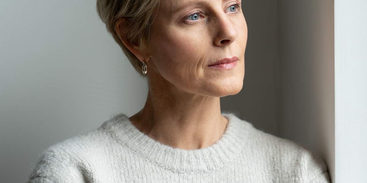 middle-aged-woman-looks-out-the-window-01-GettyImages-1357631158-2000x2000.jpg
