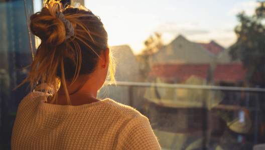 woman-looking-through-the-window-GettyImages-1221705988-3000x2000.jpg