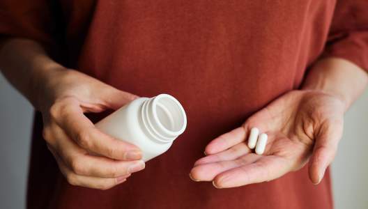 woman-pours-pills-GettyImages-1320518555-3000x2000.jpg