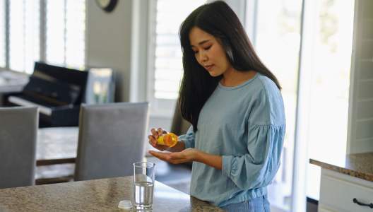 woman-taking-medication-at-home-GettyImages-1647337224-3000x2000.jpg