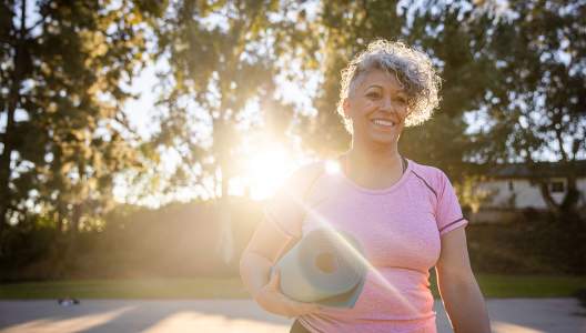 woman-walking-with-her-yoga-mat-GettyImages-1300214793-3000x2000.jpg