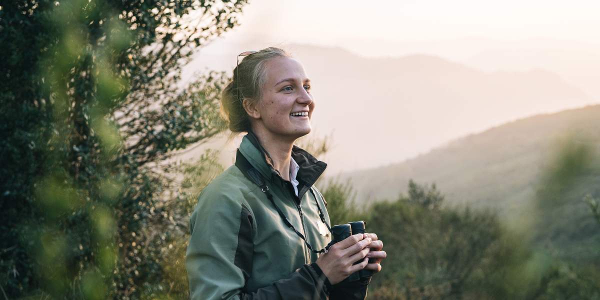 woman-watches-sunrise-over-mountains-GettyImages-1356757148-3000x2000.jpg